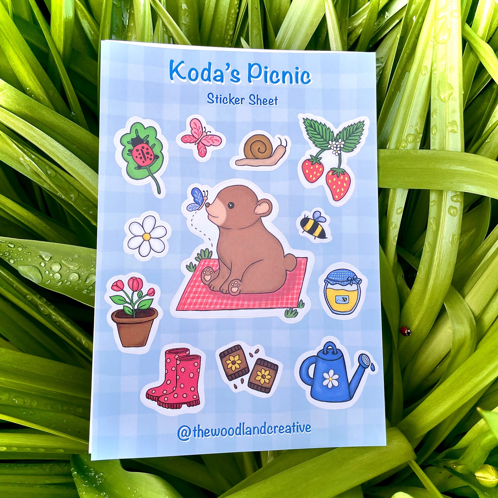 Sticker sheet titled 'Koda's Picnic' with a bear and picnic-themed stickers on a grass background.